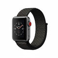 A smartwatch with a black analog-style watch face and a black woven sport band, shown on a plain white background.