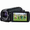A black Canon HD video camera with a large front lens and a flip-out LCD screen showing a soccer game. The camera is photographed on a clean white background.